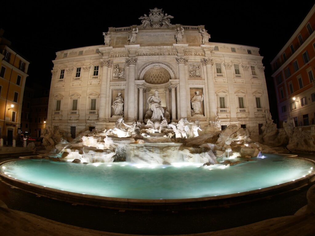 Trevi Fountain glowing in Rome at night. Photo by Stan Ritterfeld