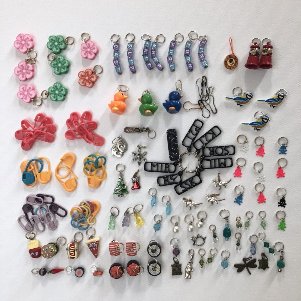 dozens of stitch markers with different designs