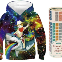 Hooded sweatshirt with cat riding a rainbow-vomiting shark beside a periodic table of elements puzzle in a tube-shaped package.
