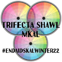 Three rainbow gradient bicycle wheels with spokes and text 'Trifecta Shawl MKAL' with the hashtag EndAIDSKALwinter22