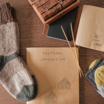Knitting journal with rubber stamps and hand knit socks. Photo by giulia bertelli