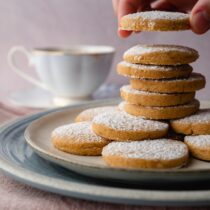 Stack of round shortbread cookies dusted with powdered sugar. Photo by Adam Bartoszewicz